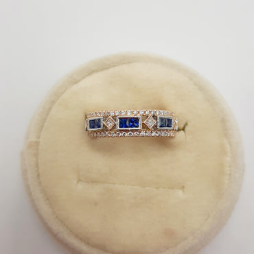 14kt yellow gold band featuring blue sapphires and natural diamonds