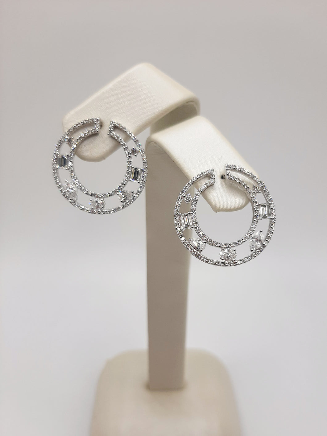 14kt white gold fashion circle earrings featuring post backs and 1.50 carats of natural diamonds