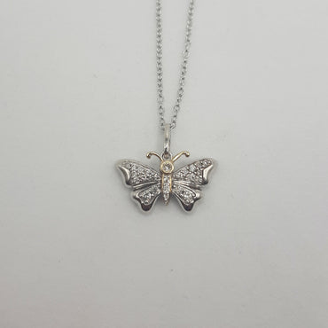 Sterling silver and 14kt yellow gold butterfly pendant featuring .20 carats of natural diamonds