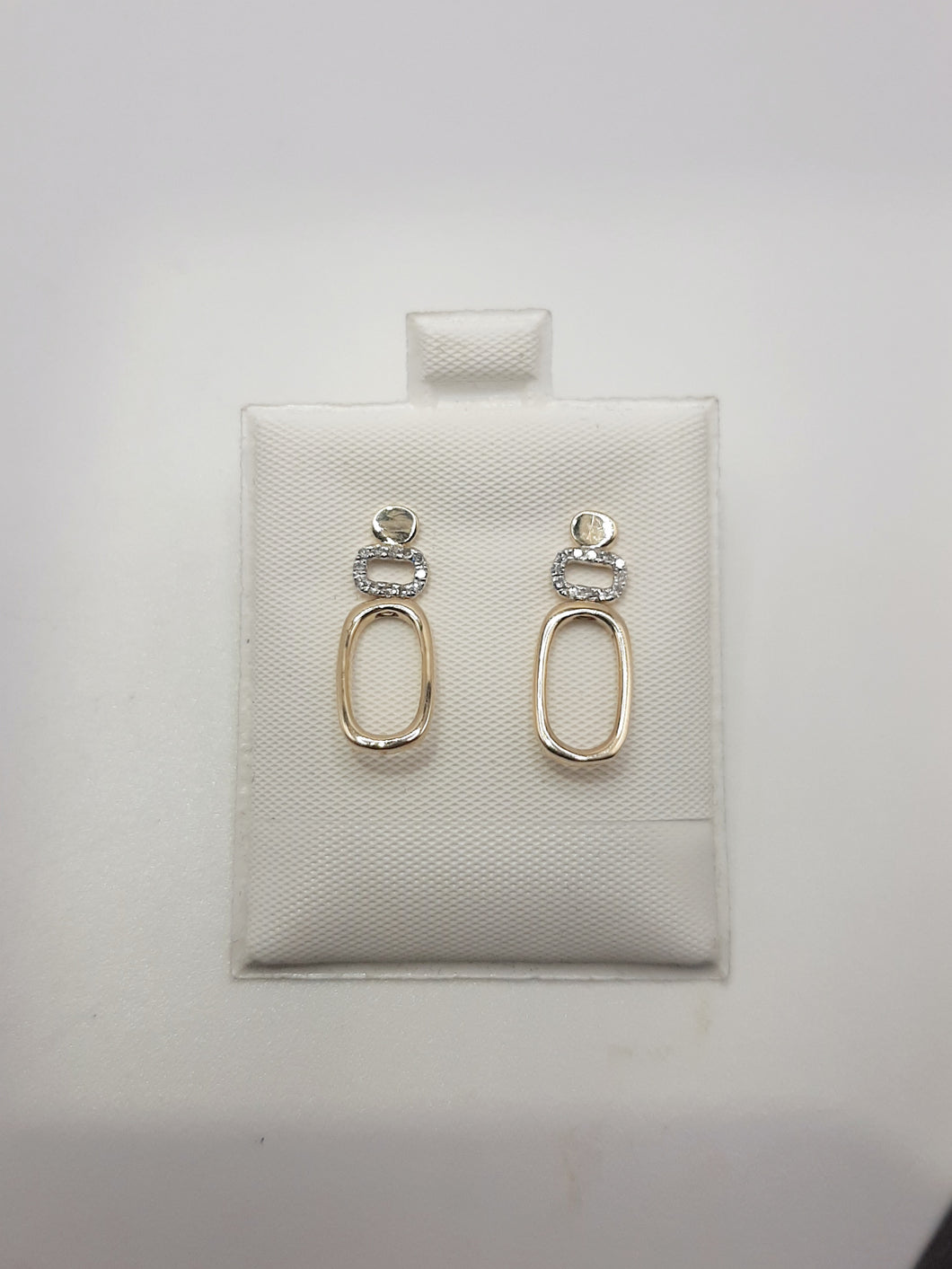 10kt yellow gold post earrings featuring long oval shape and 1/10 carat of natural diamonds