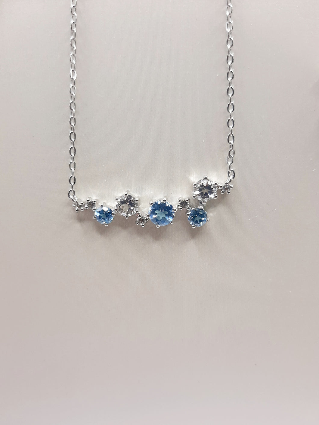 Sterling silver fashion trending necklace featuring white and blue topaz