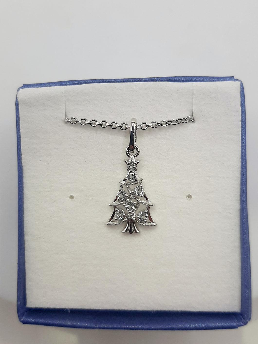 Sterling silver Christmas tree necklace featuring white and blue topaz