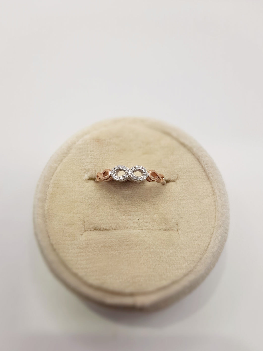 10kt white and rose gold featuring an infinity symbol with diamonds