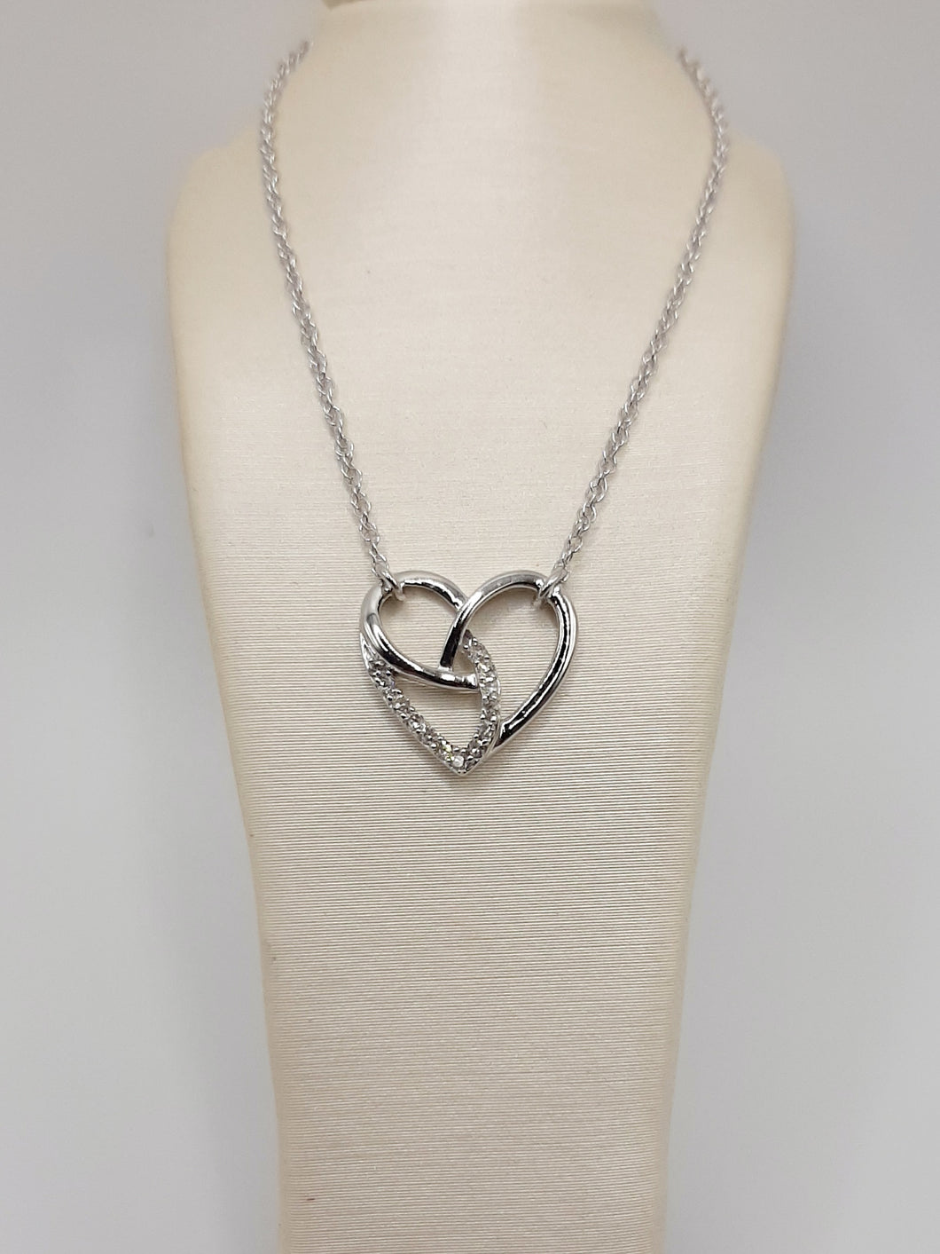 Sterling silver heart necklace featuring .07 carats of natural diamonds on an 18