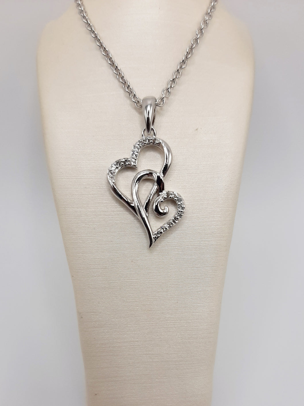 Sterling silver double heart necklace featuring white topaz on an 18