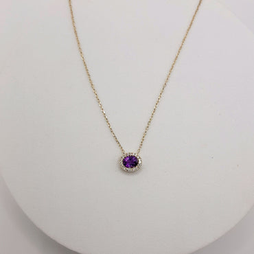 10Kt Yellow Gold  Halo Pendant Featuring an Oval Amethyst and .06 Carats of Natural Diamonds in Halo on an Adjustable Chain up to 18