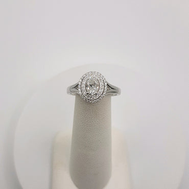 14Kt White Gold Double Halo Ring Featuring a .52 Carats Oval Solitaire and .19 Carats of Round Brilliant Cut Diamonds