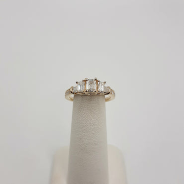 14KT Yellow Gold Three Stone Diamond Ring Featuring 1/2 Carat Center Emerald Cut Natural Diamond with 2 1/4 Carat Emerald Cut Natural Diamonds and .20 Carats of Baguette and Round Diamonds
